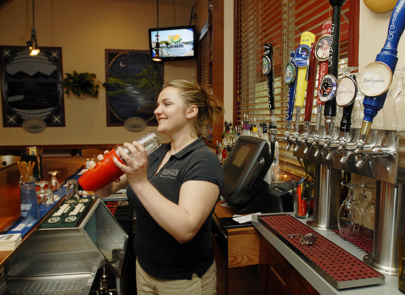Bartender Bethany Duemmling pours drafts and mixes drinks at Sebago Brewing on Elm Street in Gorham. Especially if you’re trying the beer, the smiles will come easy on the way out.
