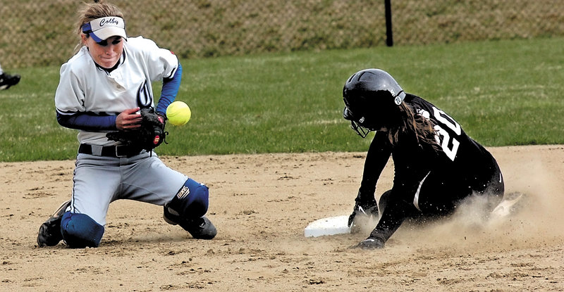 Amy Hackett of Bowdoin slides safely into second as Colby shortstop Christine Gillespie tries to field the throw Friday in Waterville. Bowdoin pulled out a 5-4 victory in 10 innings.