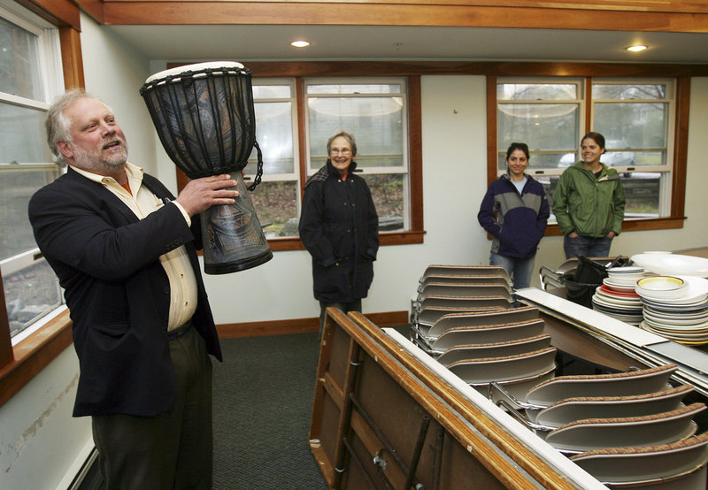 The Rev. Larry Brickner-Wood, pastor of the United Campus Ministry, holds up a drum in Durham, N.H., Friday. The building re-opened after a four-month closing to clean for anthrax.