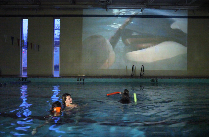 Instead of a drive-in, the Reiche Pool-as-theater is more of a noodle-in event, as the city experiments with a new way to entertain kids. On Friday, the featured attraction was “Free Willy.” Parents pay a small fee for the novel experience – $5 covers a family – and two lifeguards are on duty. Next Friday the featured flick is “The Princess and the Frog.”