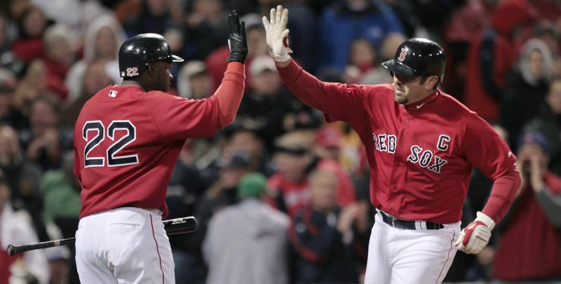 Jason Varitek, right, is greeted by Bill Hall after hitting a home run Friday against Tampa Bay. The game was suspended because of rain with the score tied 1-1 in the ninth inning.
