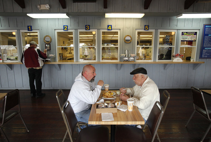 Bill Reny and his father Donald Reny eat lunch at Ken’s Place on Pine Point Road in Scarborough, which reopened for the season in March. When warmer weather comes, diners often sit at outdoor picnic tables.