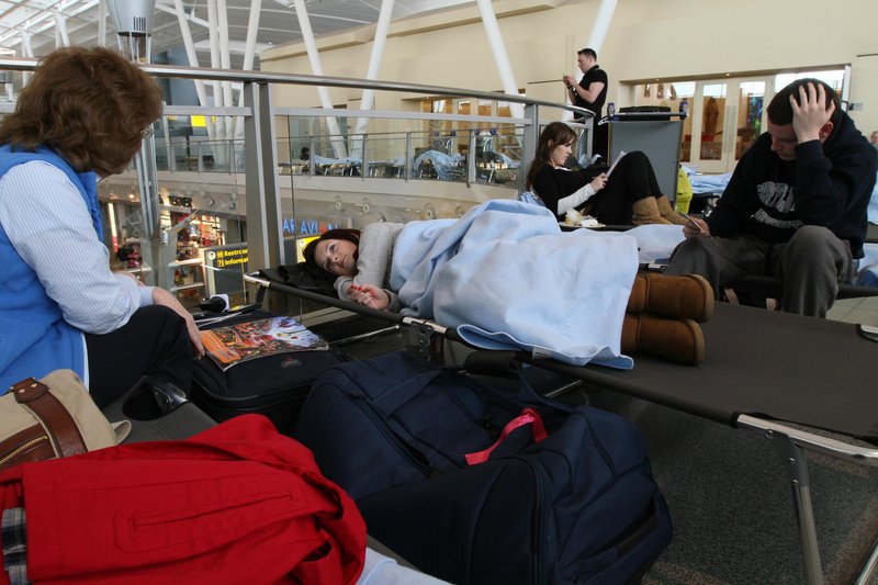 Dublin-bound passengers from Birmingham, England, wait at JFK International Airport in New York on Saturday. Airline losses have moved into the billions of dollars, and some airline officials are asking that flight restrictions caused by volcanic ash be eased.