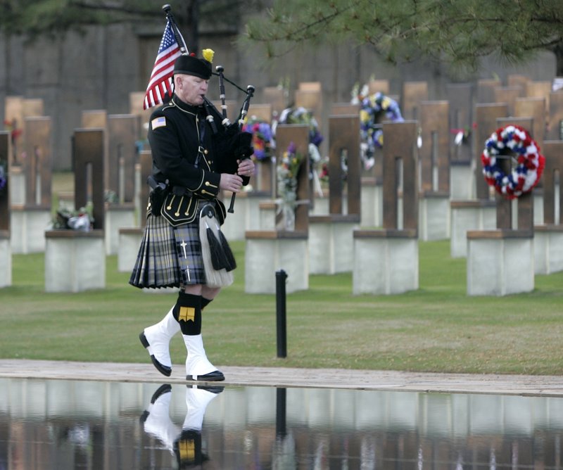 Pipe Sergeant Kevin M. Donnelly, of the DEA Black and Gold Pipes and Drums, walks past the Field of Chairs and the Reflecting Pool at the Oklahoma City National Memorial Monday, starting the ceremony on the 15th anniversary of the Oklahoma City bombing.