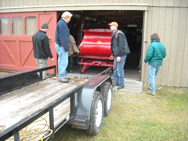 Staffers at 19th Century Historic Willowbrook Village move pieces of their carriage display from a loft in the Durgin Barn. Many of the carriages, sleigh and other pieces of equipment will be auctioned off on May 8 to help the museum enhance and preserve its core exhibit items.