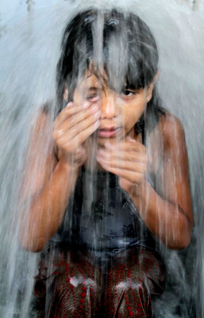 A girl takes a shower at a communal tap in Calcutta. Reports say access to clean water remains a problem for millions around the world.