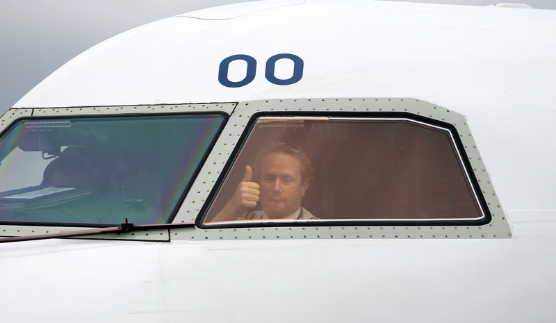 A pilot signals from the cockpit as he gets the go-ahead Tuesday to leave Belfast City Airport in Northern Ireland. Europe began allowing limited air traffic to resume, giving hope to commercial haulers and millions of travelers stranded around the world after an ash cloud from a volcano in Iceland choked jet traffic.