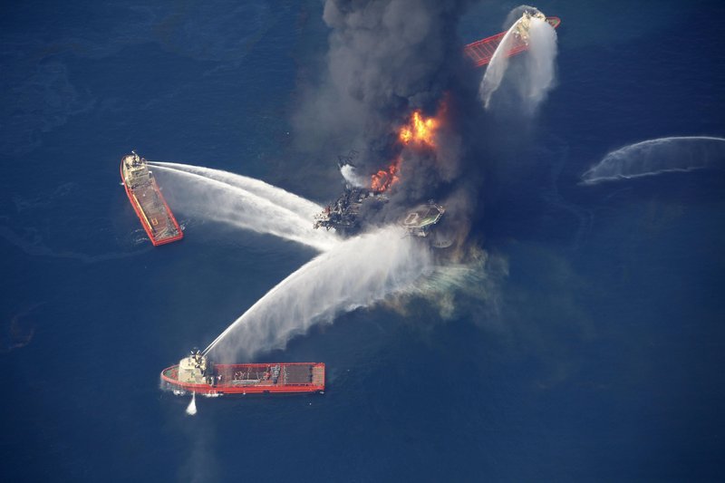 Water cannons take aim at fires burning aboard the Deepwater Horizons oil rig 50 miles southeast of Venice, La., in the Gulf of Mexico on Wednesday. Crews were recovering many of the 126 workers on the rig while also searching for 11 missing workers.
