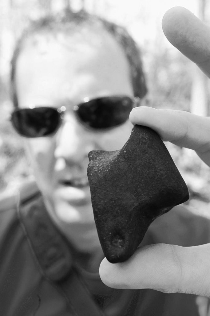 Rob Wesel, a meteorite hunter from Portland, Ore., holds a 219-gram chondrite meteorite that he found last week near Livingston, Wis. Meteorite hunters from across the nation have descended on the area looking for pieces of the meteor.