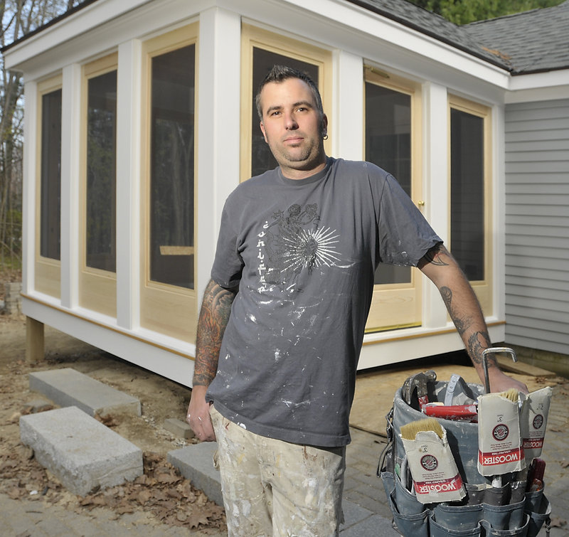 Anthony D’Agostino, owner of Custom House Painting and Restoration, takes a break Thursday while working on a home in Yarmouth. He says he favors strict laws on lead-safe practices, but the new regulations try to do too much.