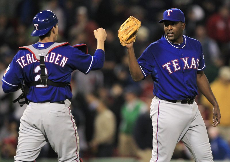 Texas Rangers pitcher Darren Oliver, right, is congratulated by catcher Taylor Teagarden after Oliver earned his first save since 1994 on Thursday night in Boston.