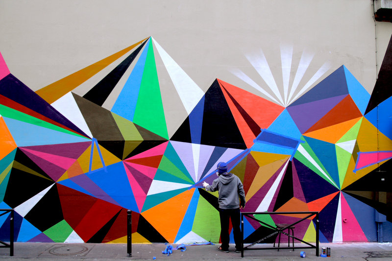 Moore works on one of his “vectorfunk” designs in Paris. Recently he also painted a mural in New York City sponsored by Ray-Ban sunglasses. His work will be shown at Fore River Gallery in Portland beginning May 7.