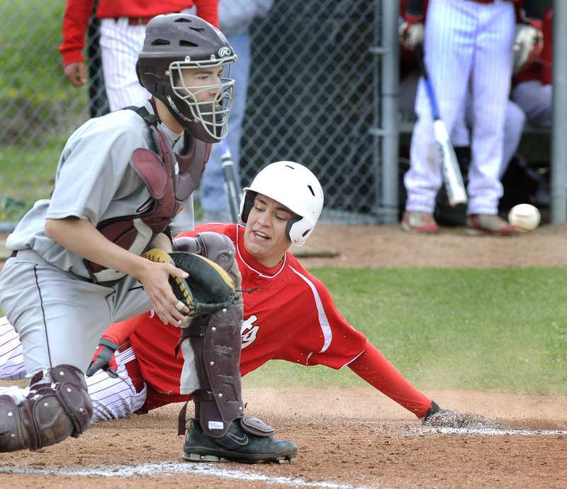 Matt Lee of South Portland slides safely across the plate as Gorham catcher Brendon Joyce waits for the throw. Friday was opening day for Telegram League baseball.