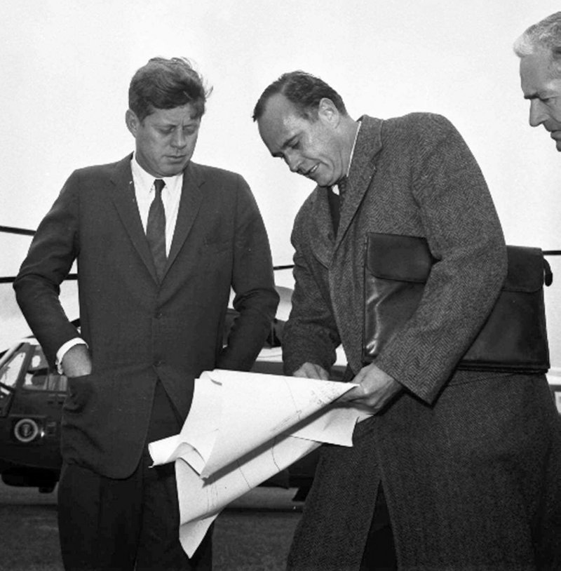 In this 1963 photo, President John F. Kennedy, left, discusses drawings with architect John Warnecke as they look over a possible site for a library to house his public papers near Harvard University in Cambridge, Mass.