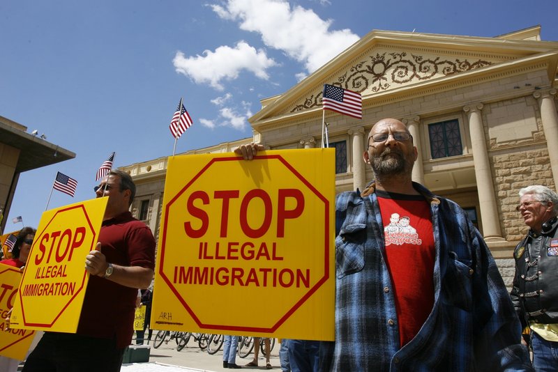 Ernie Getford holds a sign in support of an Arizona bill making it a crime not to possess proper immigration paperwork.