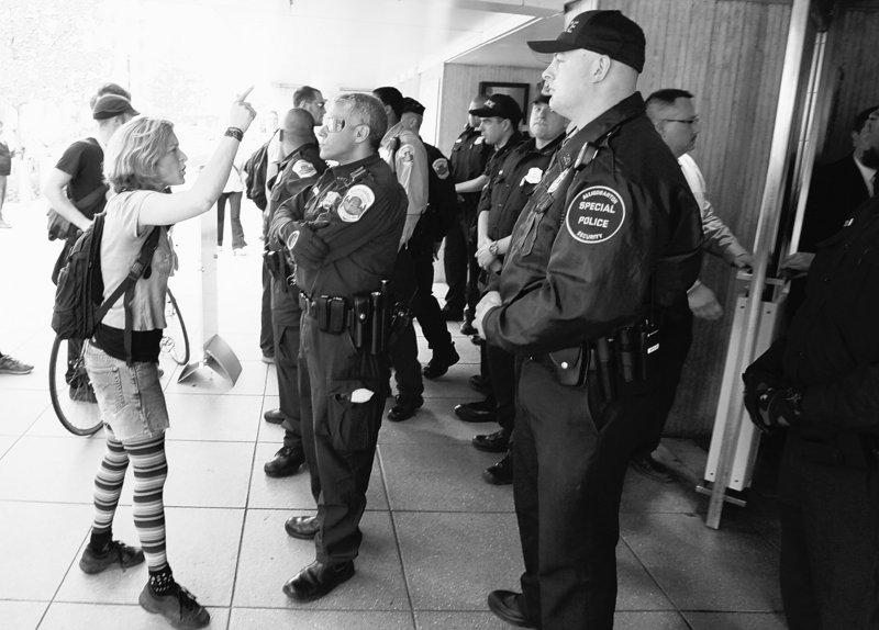 Police stand outside the World Bank doors in Washington on Friday as demonstrators protest against economic policy at the International Monetary Fund and World Bank.