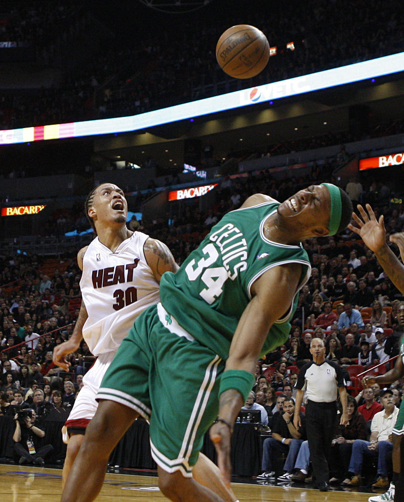 Paul Pierce of the Boston Celtics loses the ball on a drive Friday night, but later hit the winning shot to beat the Miami Heat, 100-98.