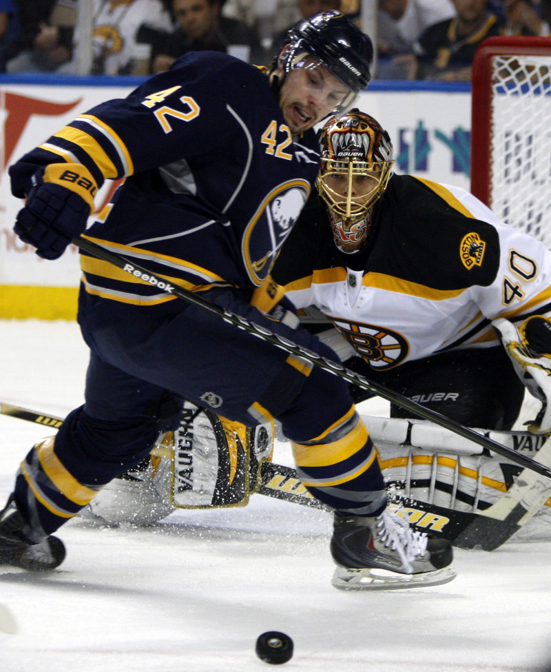 Nathan Gerbe of the Sabres tries to gain control of the puck in front of Bruins goalie Tuukka Rask during Buffalo’s 4-1 victory Friday night.