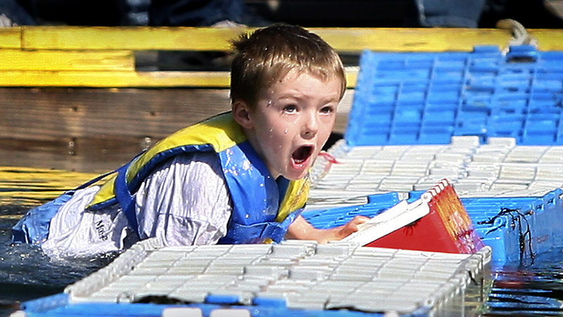 Corbin Drake, 5, made it across six crates before falling into the water during the lobster crate-running competition.