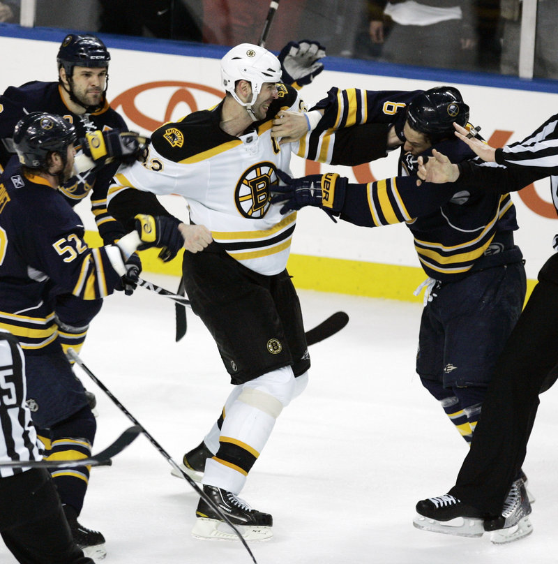 Zdeno Chara, center, the Bruins’ captain, initially was suspended by the NHL because of an instigator penalty Friday in Game 5 of the series with Buffalo, but after a review, the league decided a suspension wasn’t warranted.