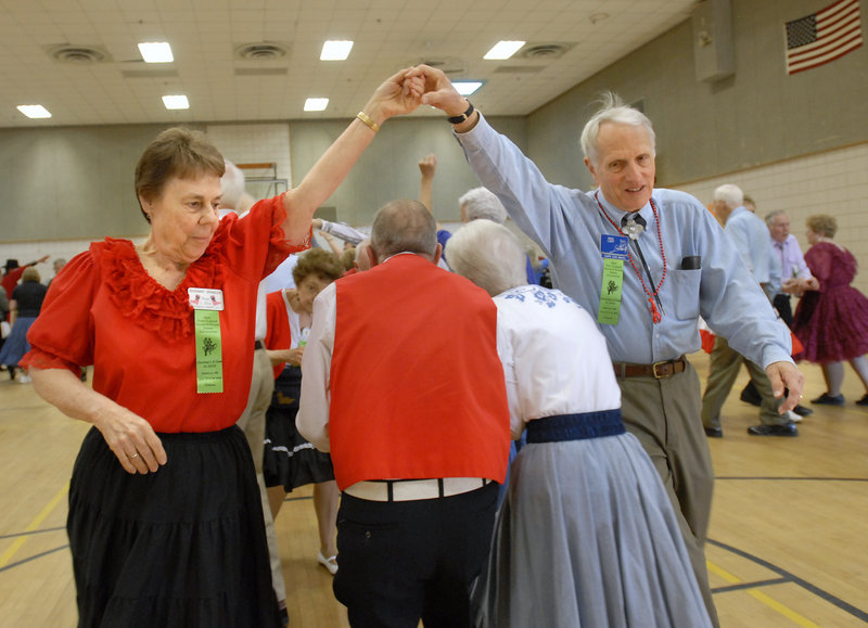 Rosemary Spengler of LaGrange, N.Y., and Dave Light of Cape Cod, Mass., make a bridge for their partners during the New England Square and Round Dance Convention.