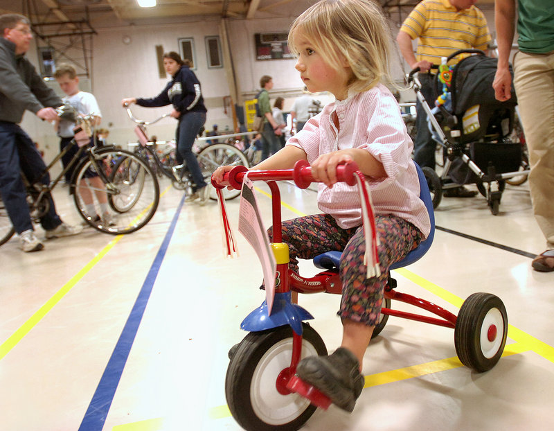 Elaina Floge, 2, of Whitefield tests a tricycle.
