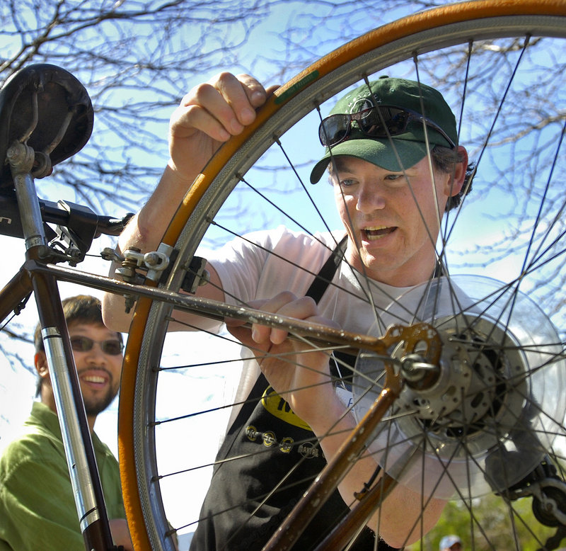 Brian Danz of Gorham Bike and Ski checks the condition of a bike for Roy Ghim of Portland, left.