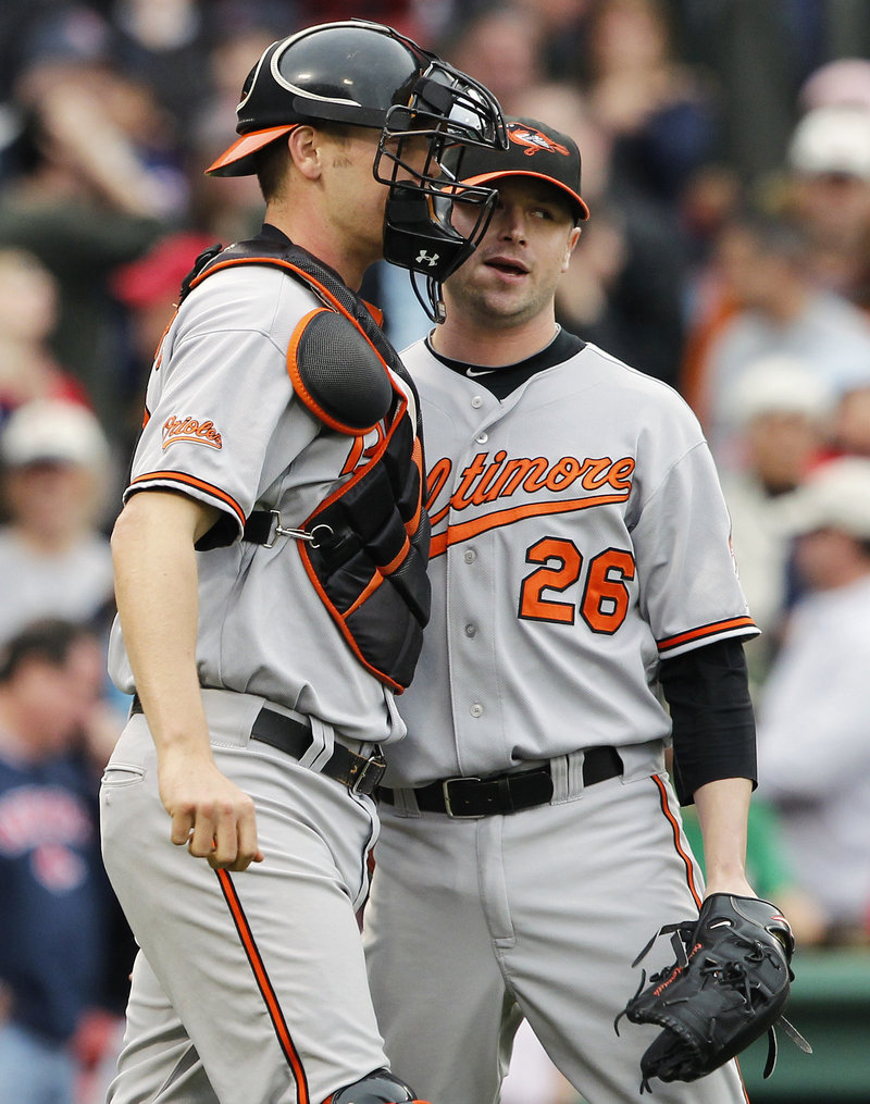 Orioles reliever Cla Meredith celebrates with catcher Craig Tatum after earning his first major league save Sunday in Baltimore’s 7-6 win over the Red Sox.