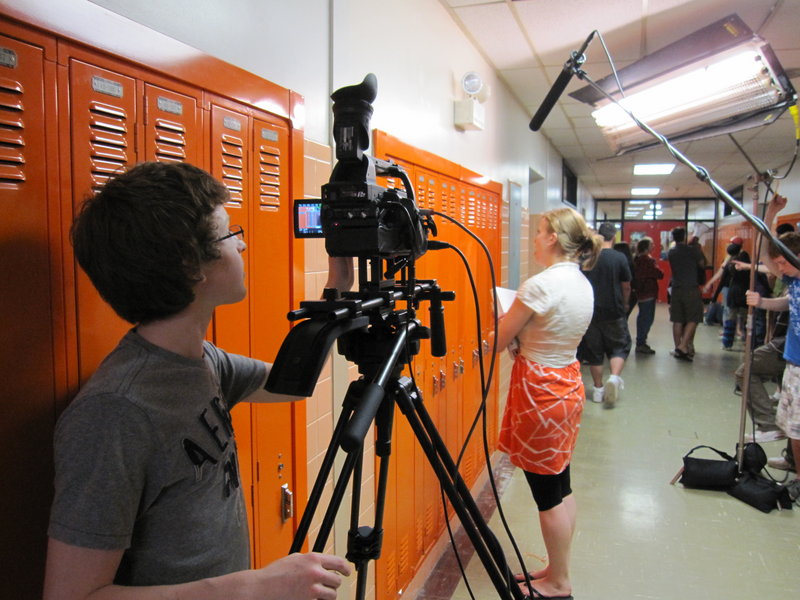 Student cameraman Patrick Higgins films a scene featuring fellow student Gwendolyn Benoit in the Sanford High School hallway. Benoit plays one of the main characters in the as-yet untitled movie.