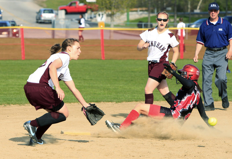 Jenn Colpitts of Scarborough slides safely into second base as Windham shortstop Nicole Kennedy waits for the throw Monday in an SMAA softball game at Scarborough. Colpitts had three of her team's 14 hits in a 13-1 win.