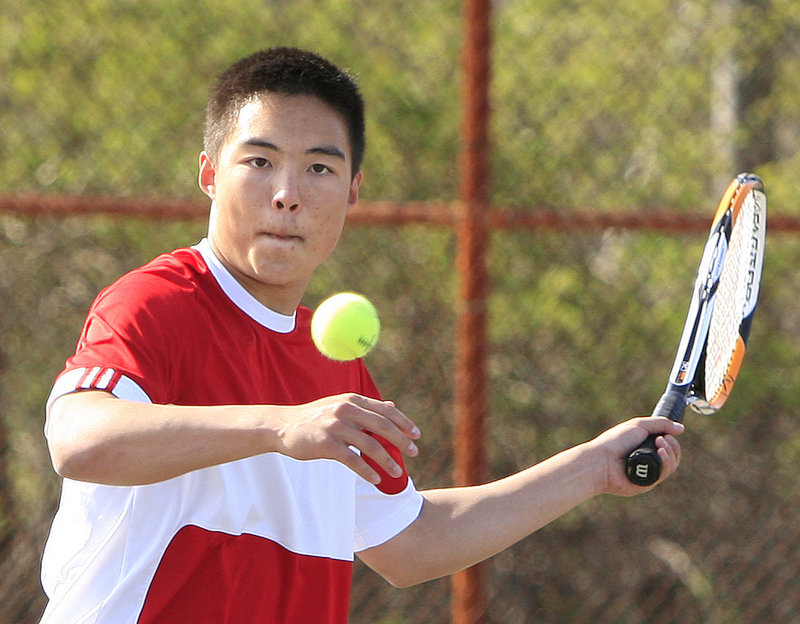 Dennis Liu returns a volley against Kurt Stultz and Nick Rallis. Both Windham and Scarborough are highly regarded this season, and they expect to meet again in the regional tournament.