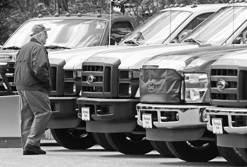 Walter Arbuckle of Braintree, Vt., looks over Ford F-150 pickup trucks at the Formula Ford dealership in Montpelier.