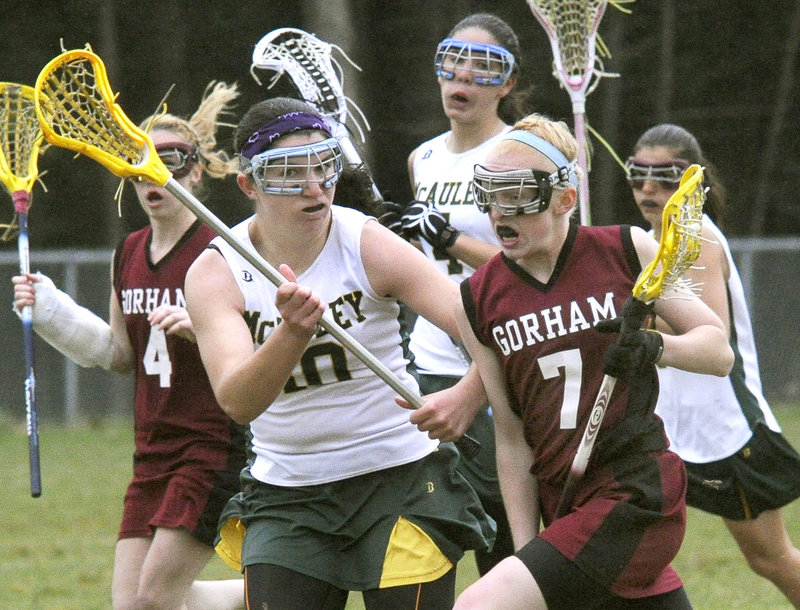 Shannon Wilcox of Gorham attempts to get past Michele Girard of McAuley during their girls' lacrosse game Tuesday. Mia Rapolla scored nine goals as Gorham earned a 17-7 victory in an opener at McAuley High.
