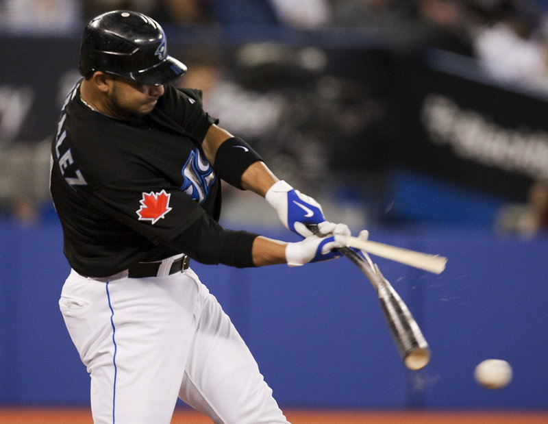 Alex Gonzalez of the Blue Jays breaks his bat as he grounds out during Tuesday’s game against the Red Sox at Toronto. Boston won on Mike tbases-loaded walk in the eighth.