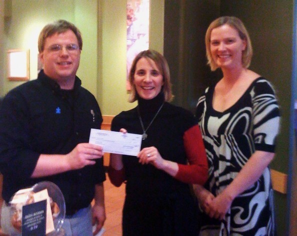Josh Montalto, of Panera Bread, left, gives a check for $2,500 to Colleen Foley-Ingersoll, REACH School director, and Lucy Lambert, the REACH School program coordinator.