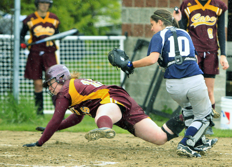 Gregory Rec/Staff Photographer Delaney Rockwell of Cape Elizabeth goes sprawling after getting tagged out by Fryeburg Academy catcher Carla Tripp while trying to score during Wednesdays softball game at Cape Elizabeth. Fryeburg improved to 3-0 with a 6-4 victory.