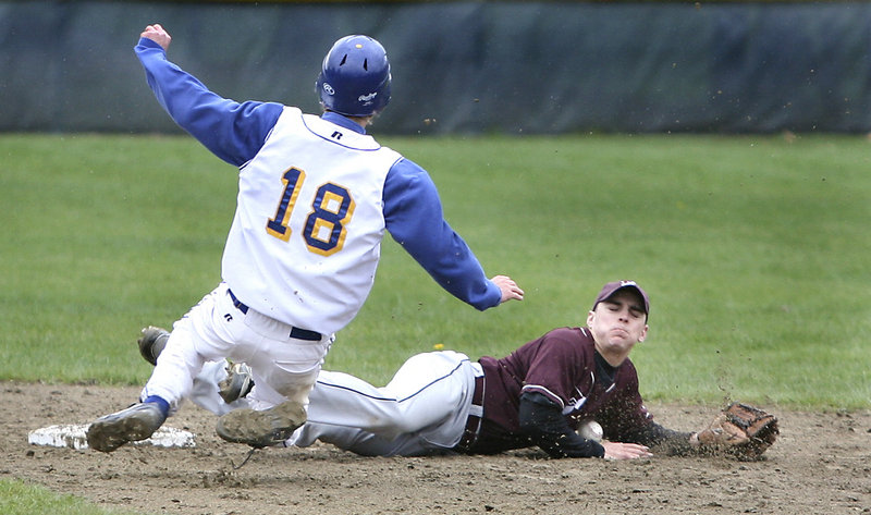 Joe Barnes of Falmouth steals second base Wednesday as Kyle Moore of Freeport stops the ball with his body. Falmouth won 11-2 in a Western Maine Conference game at Freeport that was stopped in the fifth inning because of rain.