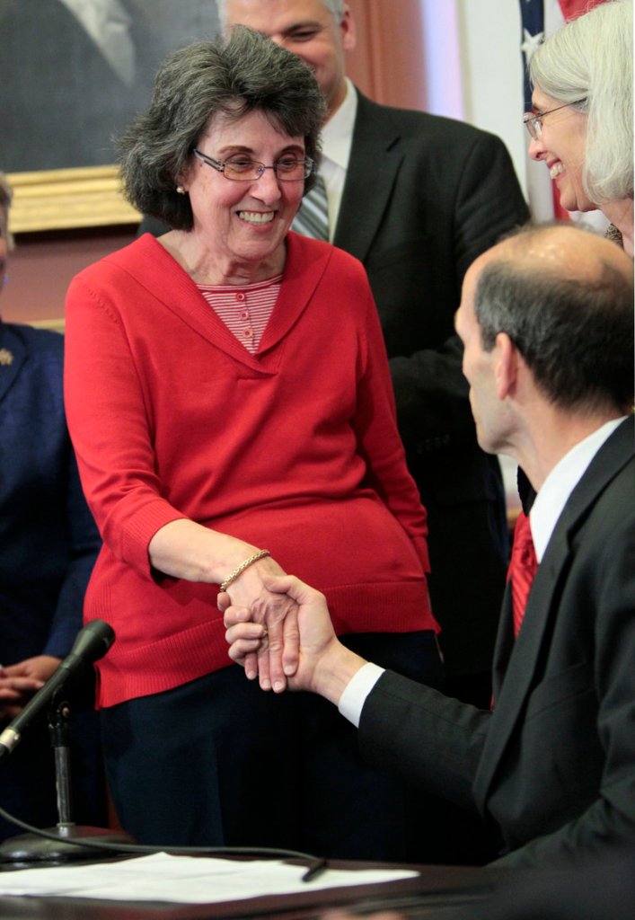 Claire Young shakes hands with Gov. John Baldacci at the State House on Thursday during a ceremony for a new Maine law called the Silver Alert. The law creates a program for missing seniors modeled after the Amber Alert system for abducted children.