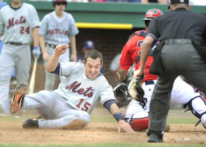 Luke Montz of the Binghamton Mets reaches to touch the plate Wednesday as catcher Juan Apodaca of the Portland Sea Dogs takes a late throw in the fourth inning of Binghamton’s 10-4 victory at Hadlock Field. The Dogs are now on the road until April 30.
