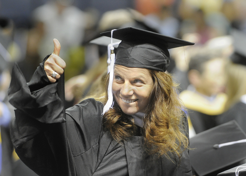 Susan Marean, of Gorham, gives a thumbs up to family and friends after receiving her degree in social work at today's graduation ceremony for the University of Southern Maine at the Cumberland County Civic Center.