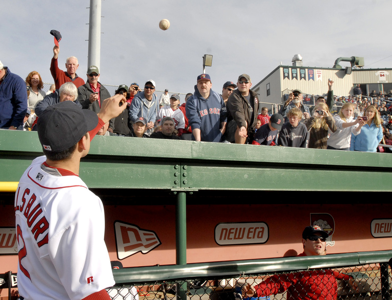 An autograph-seeking fan tosses a ball to Jacoby Ellsbury of the Boston Red Sox before Tuesday night’s Sea Dogs game at Hadlock Field in Portland. Ellsbury, recovering from a rib injury, was in the lineup for the Sea Dogs against the New Britain Rock Cats.