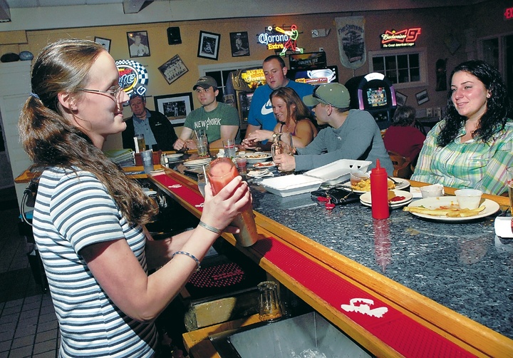 Bartender Nicole Bourgeois mixes drinks at The Landing in North Windham. Donald and Alyssa Gordon have owned The Landing for more than two years and have reinvented the atmosphere and food with a wide variety of libations and menu items.