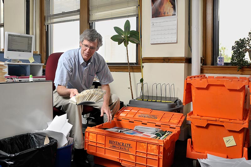 John Richardson, a reporter with The Portland Press Herald, has to decide what to save and what to throw out as he packs his belongings for the editorial staff’s move to One City Center.