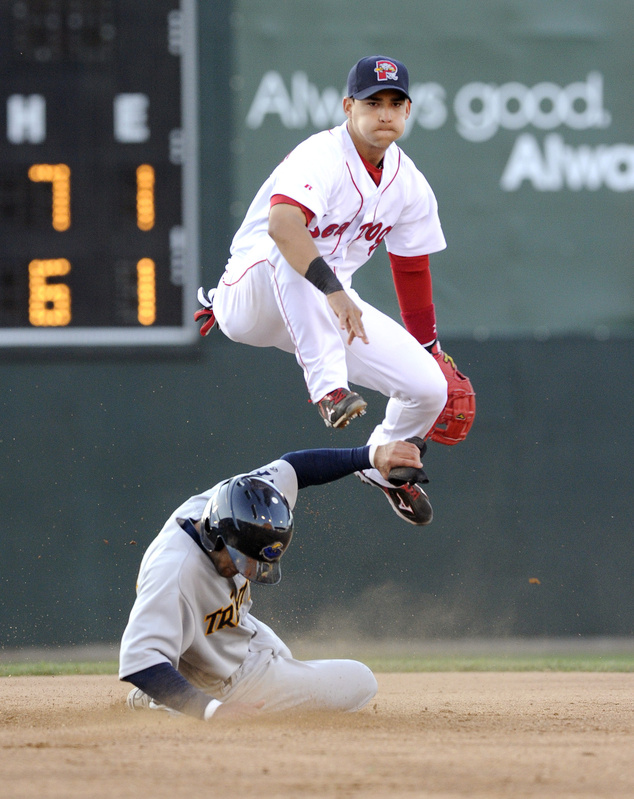 Trenton’s Justin Christian slides under Portland’s Jose Iglesias at second base as Iglesias completes a double play Friday night at Hadlock Field. The teams play a doubleheader May 22.