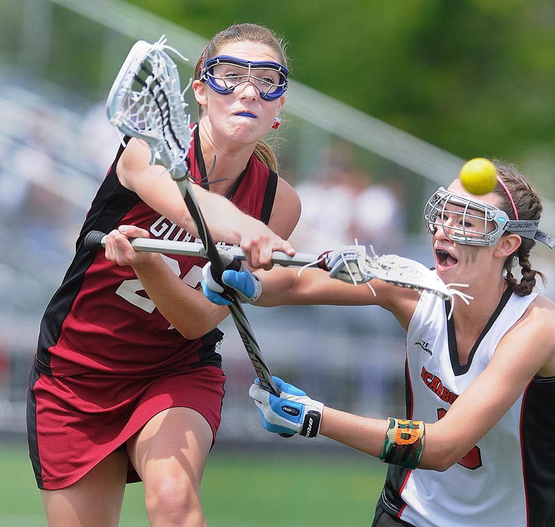 Mia Rapolla of Gorham fires a shot past Dani Foster of Scarborough for one of her nine goals Saturday during a schoolgirl lacrosse game. Scarborough emerged with a 17-15 victory.