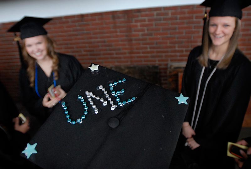University of New England graduate Morgan Wood shows off her specially adorned cap during graduation ceremonies in Portland on Saturday.
