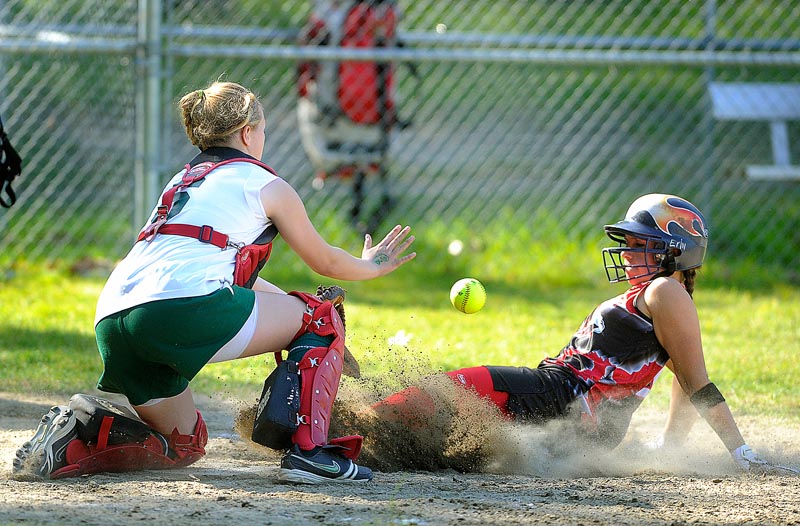 Erin Giles of Scarborough beats the throw to McAuley catcher Sam Schildroth for a three-run homer in the third inning Monday. Mo Hannan also hit a three-run homer and struck out 10 in four innings, leading Scarborough to a 15-0 victory.