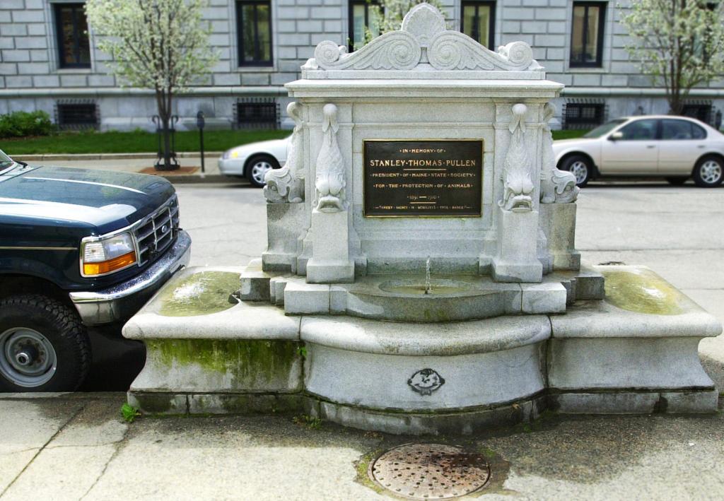 Staff Photo by Gordon Chibroski, Wed, May 09, 2001: This Stanley Pullen Memorial Fountain on Federal St. gets no respect as a pickup truck is parked so close, the monument is embedded into the license plate at the corner that is broken off Gordon Chibroski