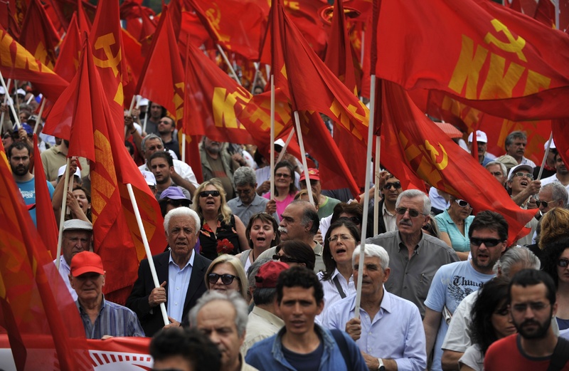 Greek Communist Party supporters shout anti-government slogans during a rally in central Athens on Saturday. The government has imposed deep cuts in wages and Greek Communist Party supporters shout anti-government slogans during a rally in central Athens on Saturday. The government has imposed deep cuts in wages and pensions and has raised taxes as part of a rescue package agreed to with the European Union and the International Monetary Fund to stave off bankruptcy.