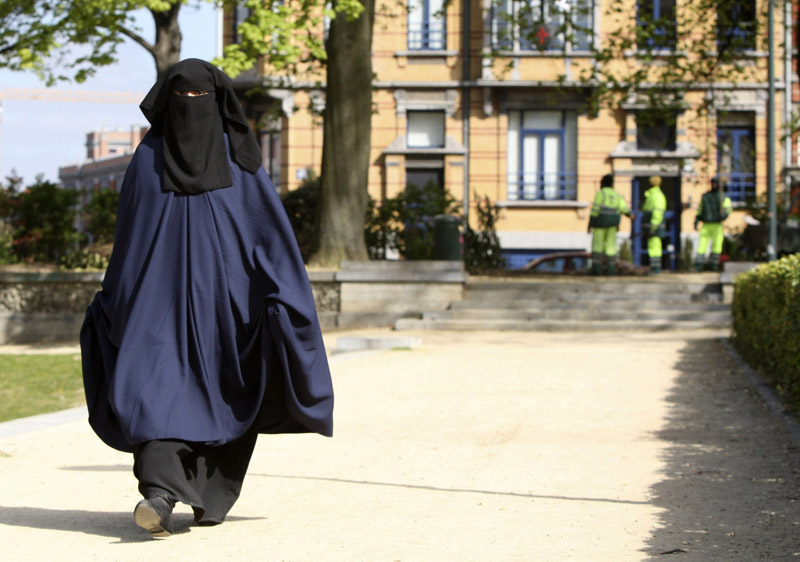 In this April 22 photo, a woman wears the niqab as she walks in a park in Brussels.